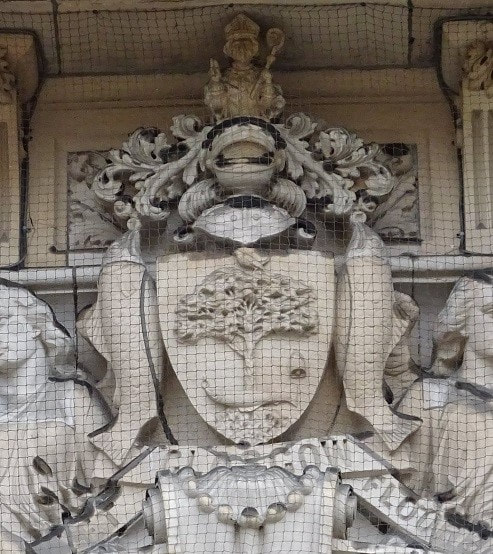 An intricate, ornate Victorian coat of arms above the main entrance to the City Chambers